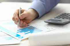 Diagramme, Taschenrechner und Hand mit Stift